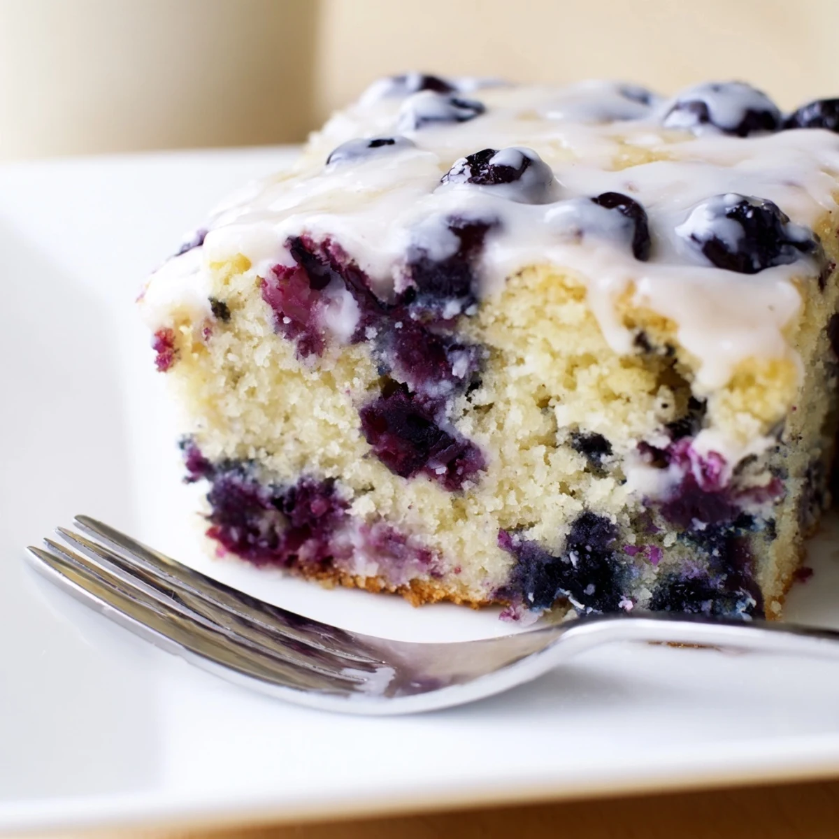 Fluffy Blueberry Pancake Soda Sheet Cake topped with a sweet vanilla glaze.  