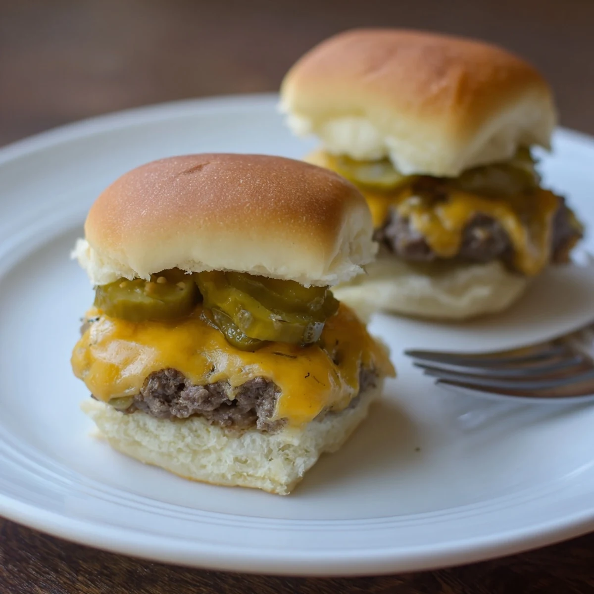 Delicious Dill Pickle Ranch Sliders featuring melted cheese and savory beef patties in soft buns.  