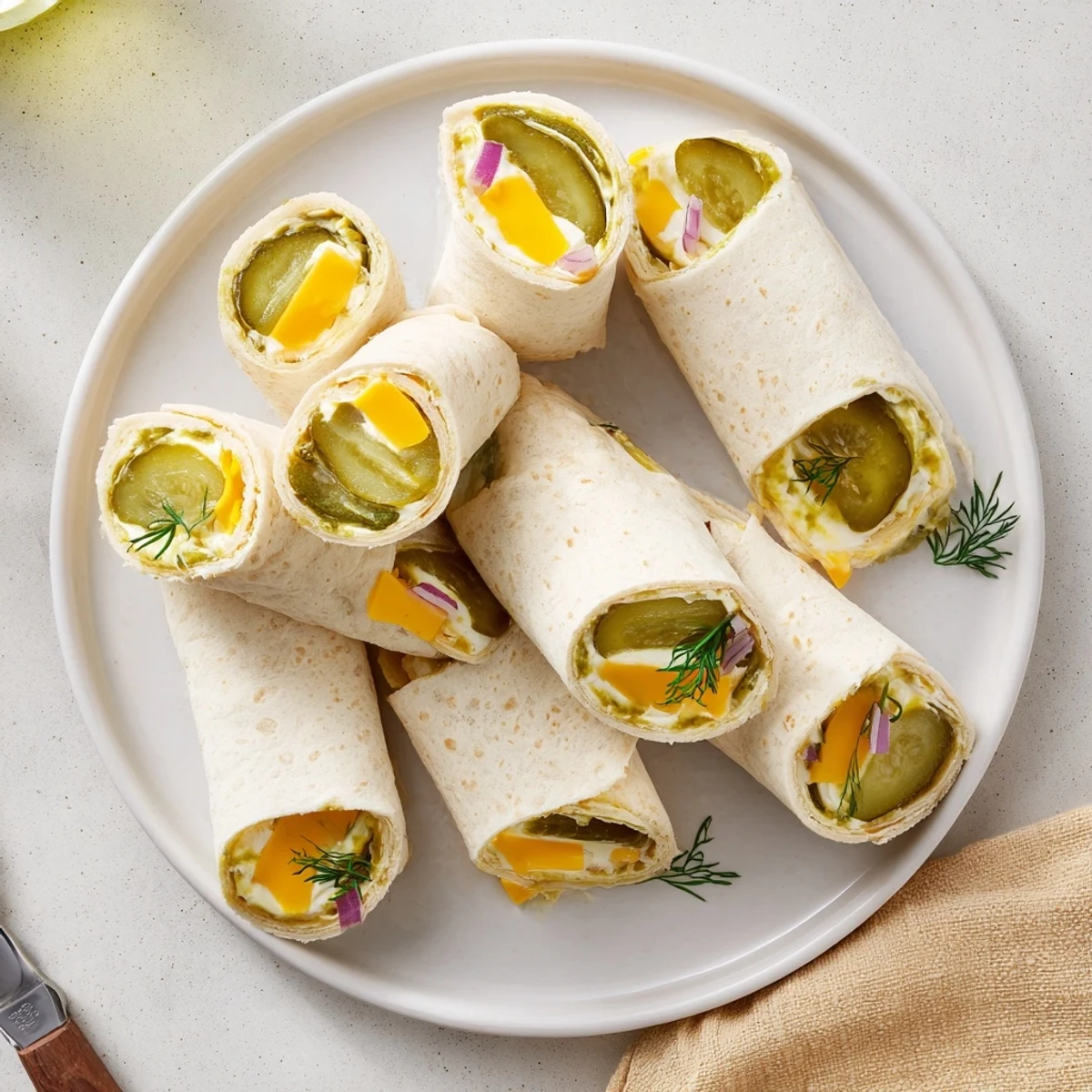 Tangy pickle-in-a-blanket bites, perfect for fun gatherings or casual picnics.