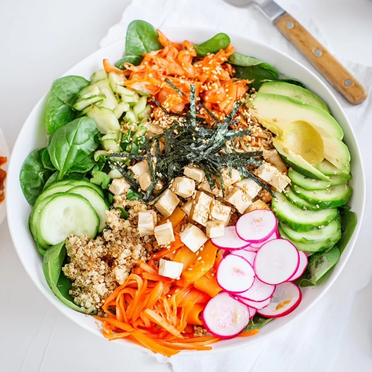 Colorful fermented vegetable bowl featuring tangy kimchi and nutritious grains, ready to serve.  