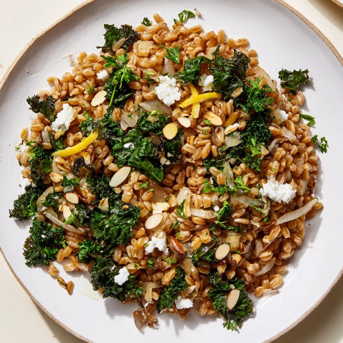 Steaming bowl of Warm Farro & Greens Pilaf, topped with golden toasted almonds and herbs.
