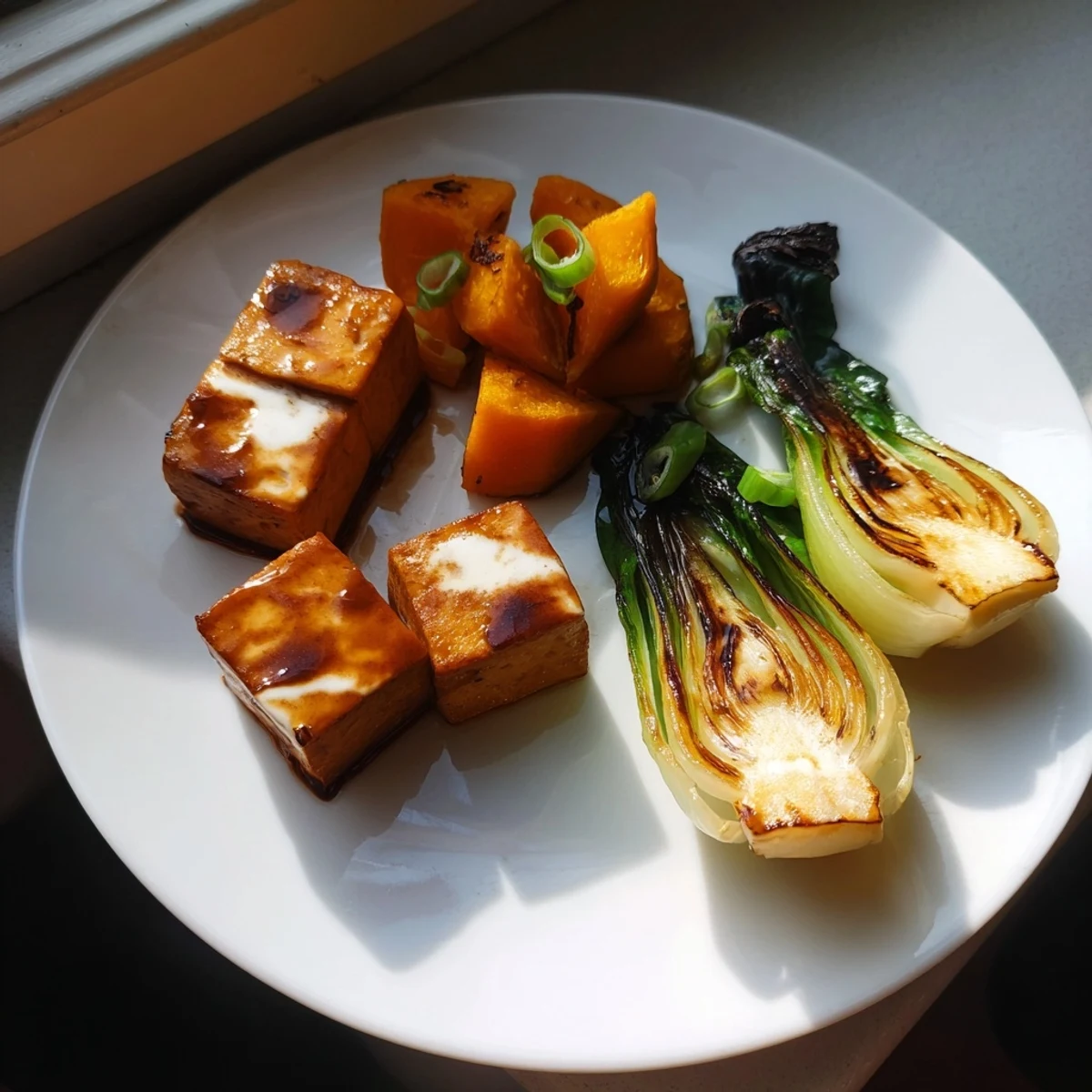 Golden brown miso-glazed tofu and winter squash with tender bok choy, a delicious vegan dinner.