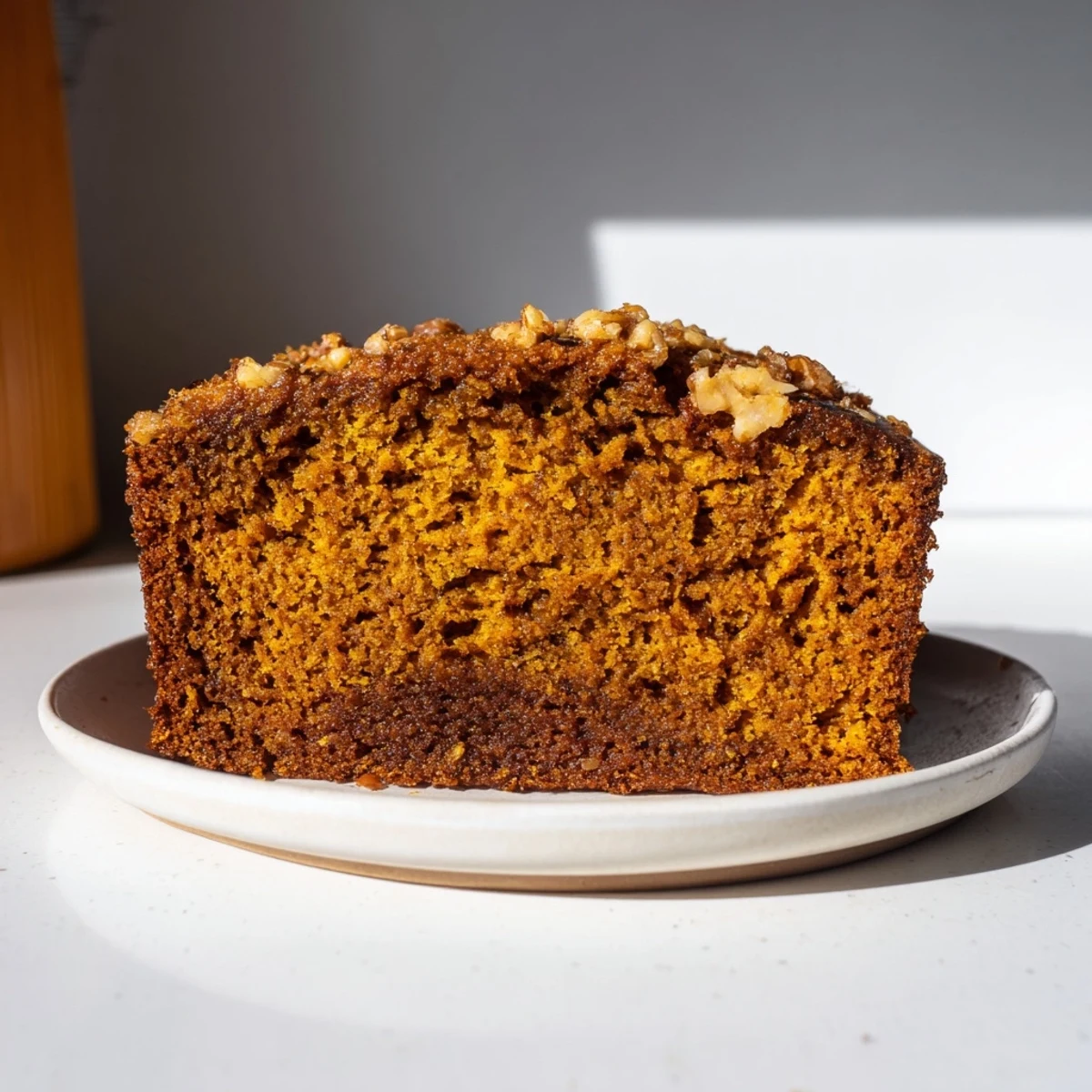 Close-up of a mug with pumpkin bread freshly baked, promising comforting fall flavors to enjoy.