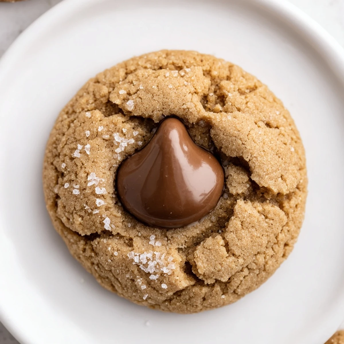 Warm, freshly baked 3-Ingredient Peanut Butter Blossoms, with melted chocolate kiss centers, ready to enjoy.