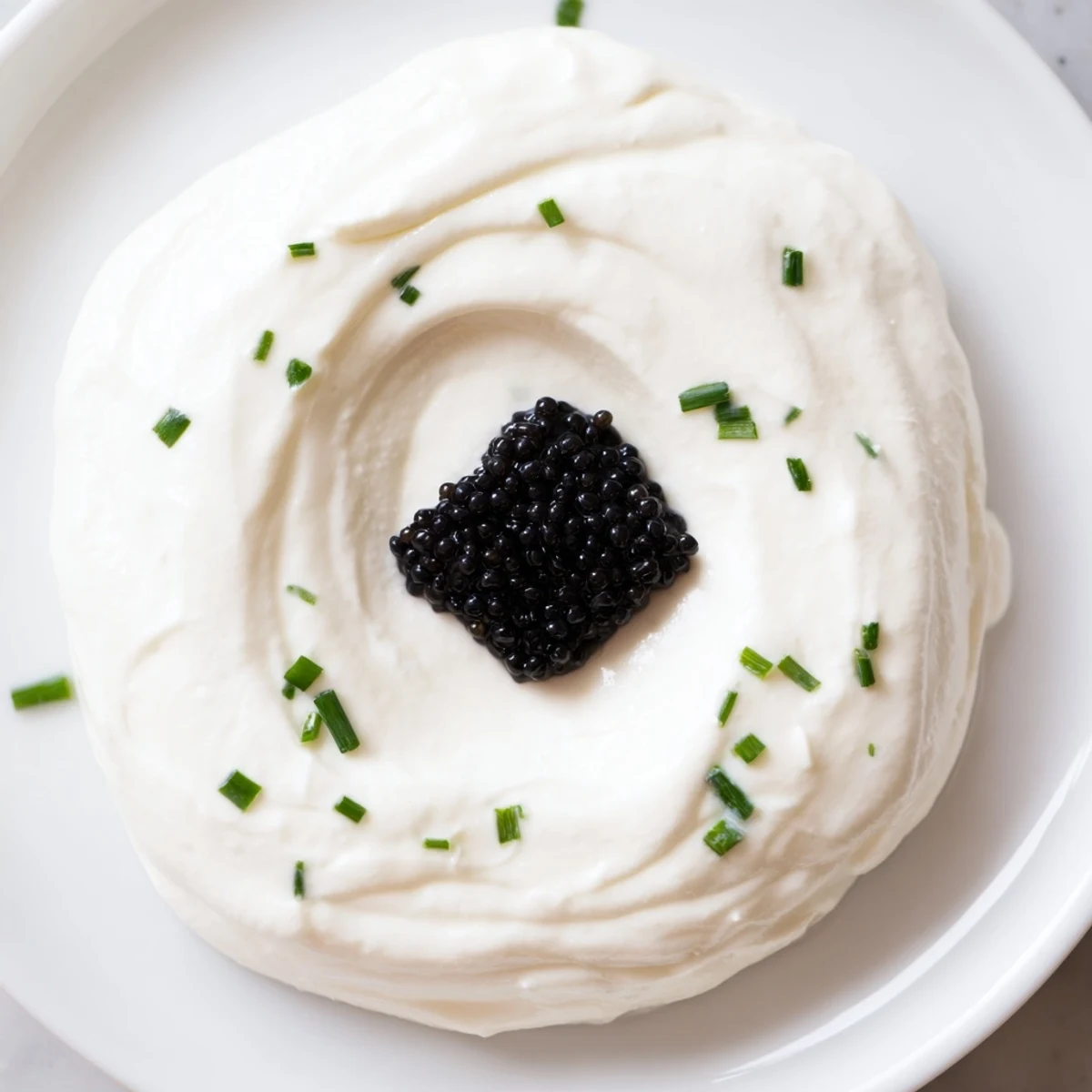 Imagine this: The Diamond Inlay, a stunning appetizer with caviar, surrounded by fluffy cream cheese and herbs.