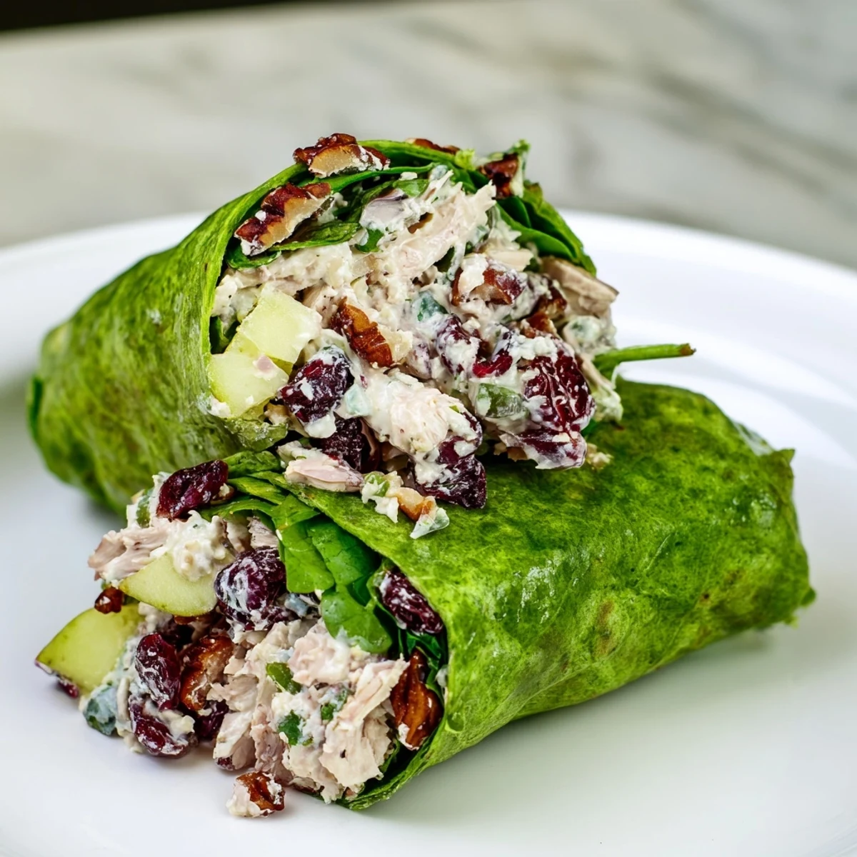 Savory Cranberry Pecan Chicken Salad Christmas Wrap, ready to eat, showing a colorful cross-section with creamy filling.