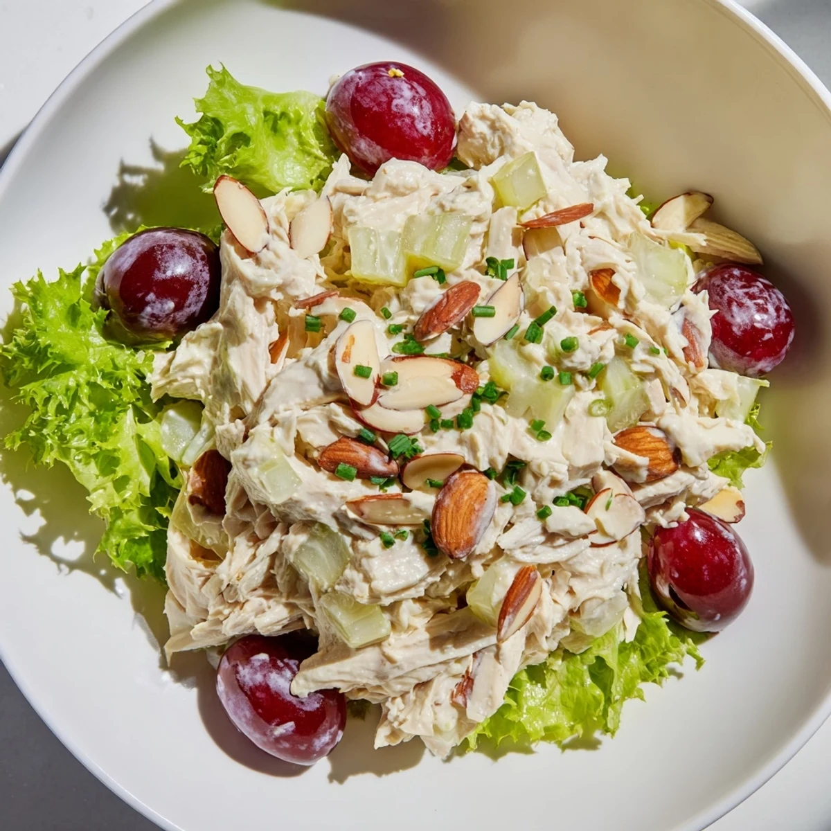Creamy Crispy Chicken Salad with a bed of fresh greens and juicy red grapes, delicious!