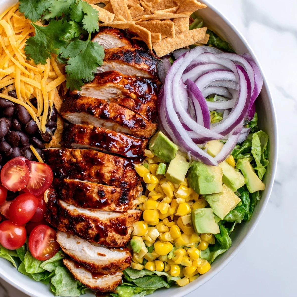 Freshly grilled honey lime chicken rests atop a vibrant salad of romaine, corn, black beans, and diced avocado.  