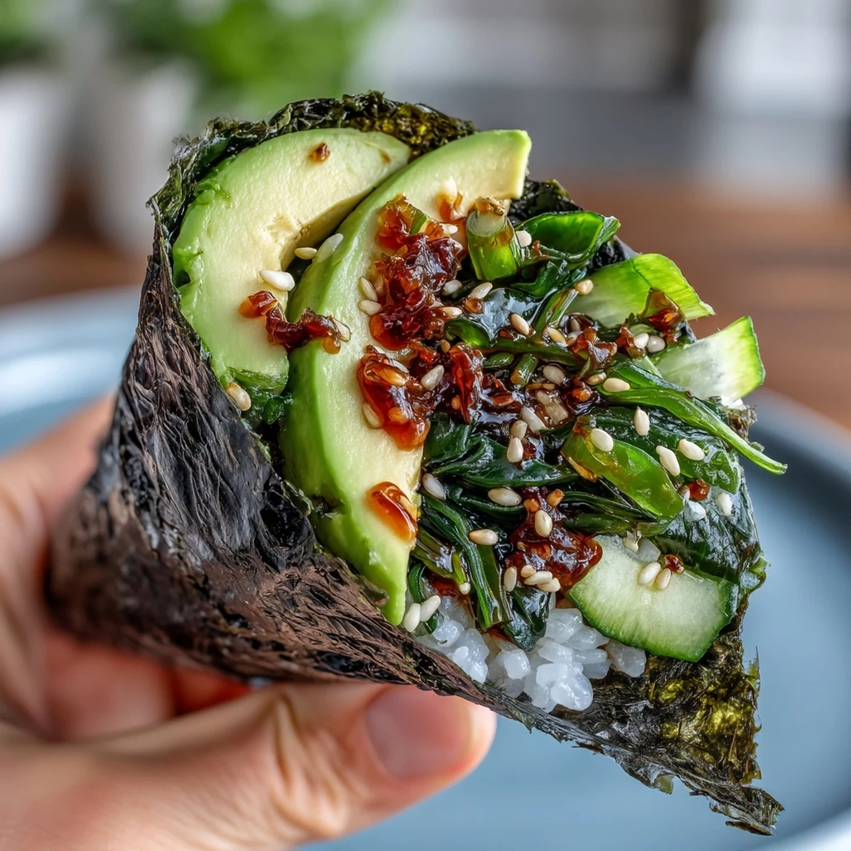 Fresh nori cones packed with sushi rice, vibrant seaweed salad, cucumber, and a drizzle of spicy mayo for a flavorful bite.  