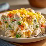 Scoops of warm Creamy Chicken and Rice Casserole& easy freezer friendly weeknight meal.