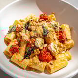 Warm, creamy Baked Goat Cheese Snowflake Pasta with roasted tomatoes and golden, bubbly cheese.