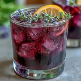 This refreshing lavender lemonade bursts with bright citrus and floral notes, featuring a beautiful purple hue perfect for warm-weather sipping or gatherings.