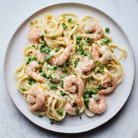 Steaming Instant Pot shrimp Alfredo pasta, a simple recipe, with creamy sauce and fresh parsley.