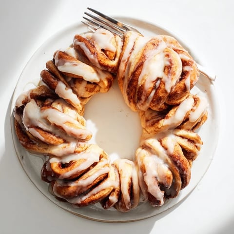 A warm, golden-brown Cinnamon Roll Pull-Apart Wreath, perfect for sharing at a festive brunch.