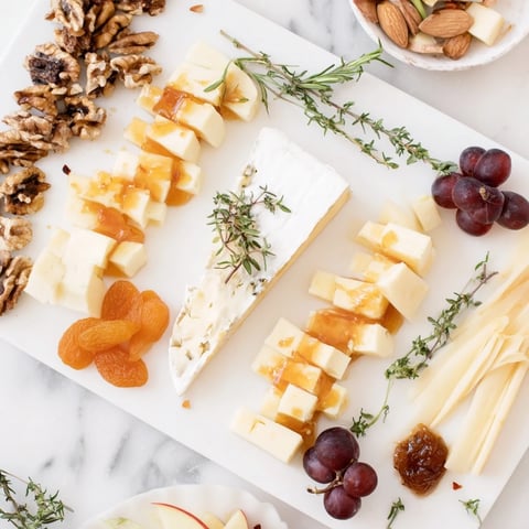 A beautifully arranged Twelve Days of Cheese Board, featuring assorted cheeses and pairings, ready to serve.