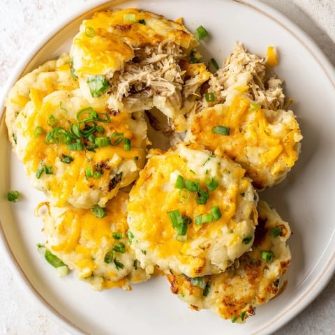 Golden-brown Potato and Chicken Cakes, crispy on the outside, showcasing their flavorful, tender filling.