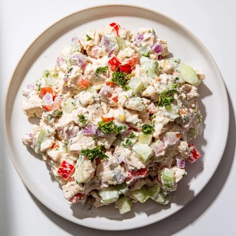 Creamy canned chicken salad with Mrs. Dash, celery, and red pepper, ready to serve.
