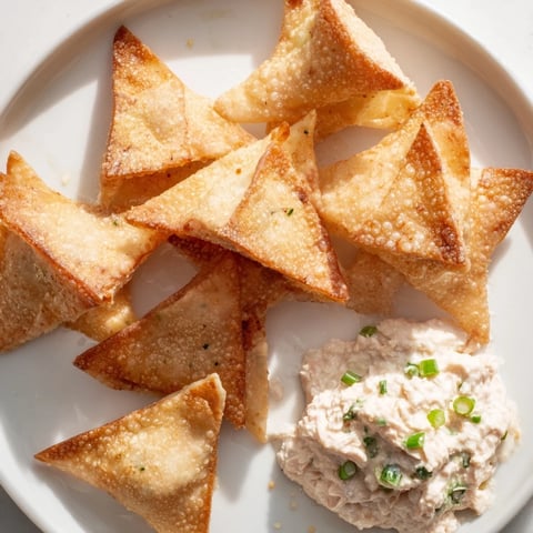 Golden, crispy Air Fryer Lumpia Chips ready to dip in creamy chicken cream cheese, perfect snack.