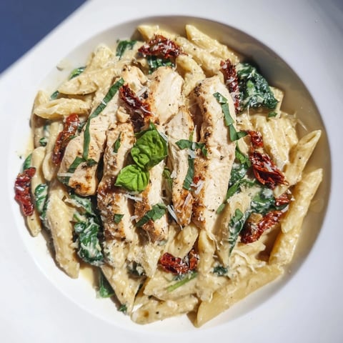 Creamy Tuscan Chicken Pasta with tender chicken, sun-dried tomatoes, and a rich, creamy sauce.