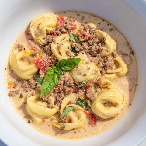 Steaming bowl of Tortellini Beef Soup, brimming with tender tortellini and flavorful broth, ready to enjoy.