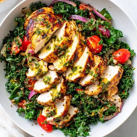 Colorful Chimichurri Grilled Chicken Bowl featuring rich garlic sauce and fresh tomatoes.  
