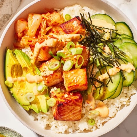 Vibrant Crispy Salmon Rice Bowl with fluffy rice, tangy kimchi, and crispy garlic.  