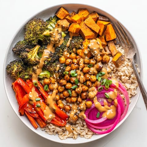 Colorful grain bowls topped with gochujang-maple sauce and crispy chickpeas.  