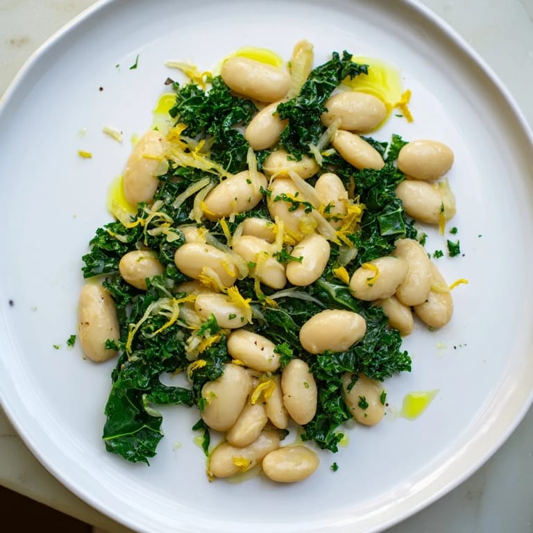 Close-up of the garlicky beans with winter greens, showcasing the tender greens and creamy beans.