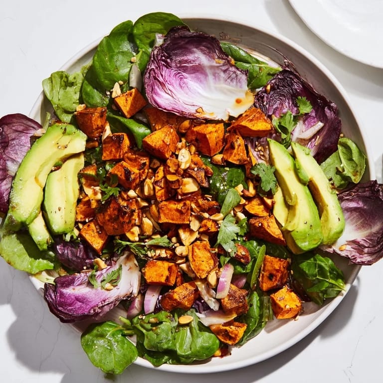 A colorful Spiced Peanut Sweet Potato & Radicchio Salad Bowl shows off the nutty dressing drizzled over fresh ingredients.