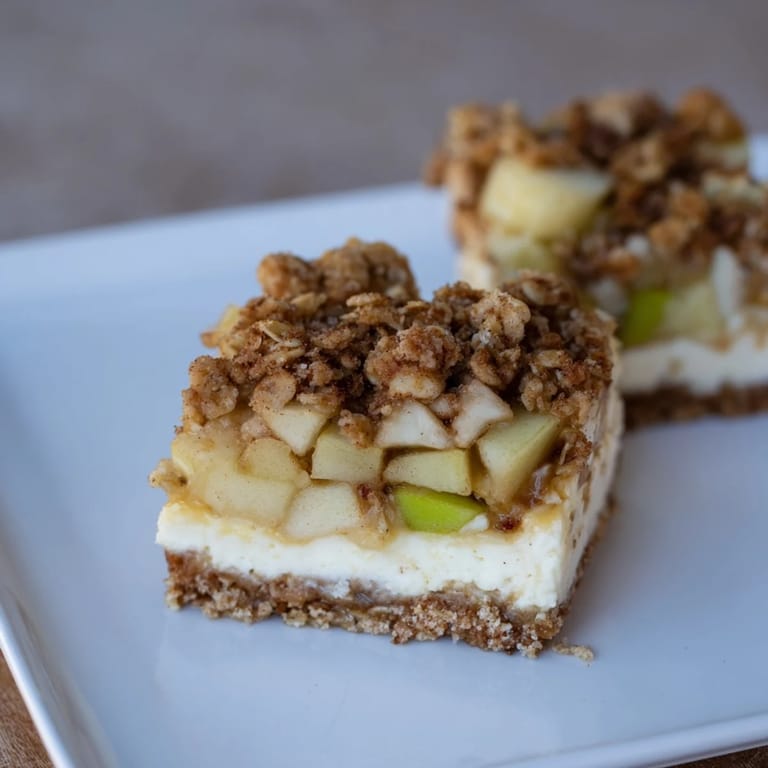 Warm, spiced apple filling layered beneath creamy cheesecake and a crispy oat topping on these apple crisp cheesecake bars.